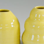 Load image into Gallery viewer, Close up of glazing of small yellow pottery bud vases 
