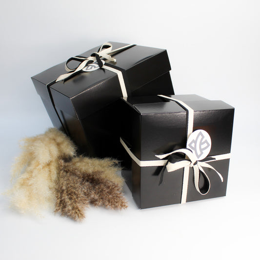 Two black boxes wrapped using Keeeps gift wrapping service