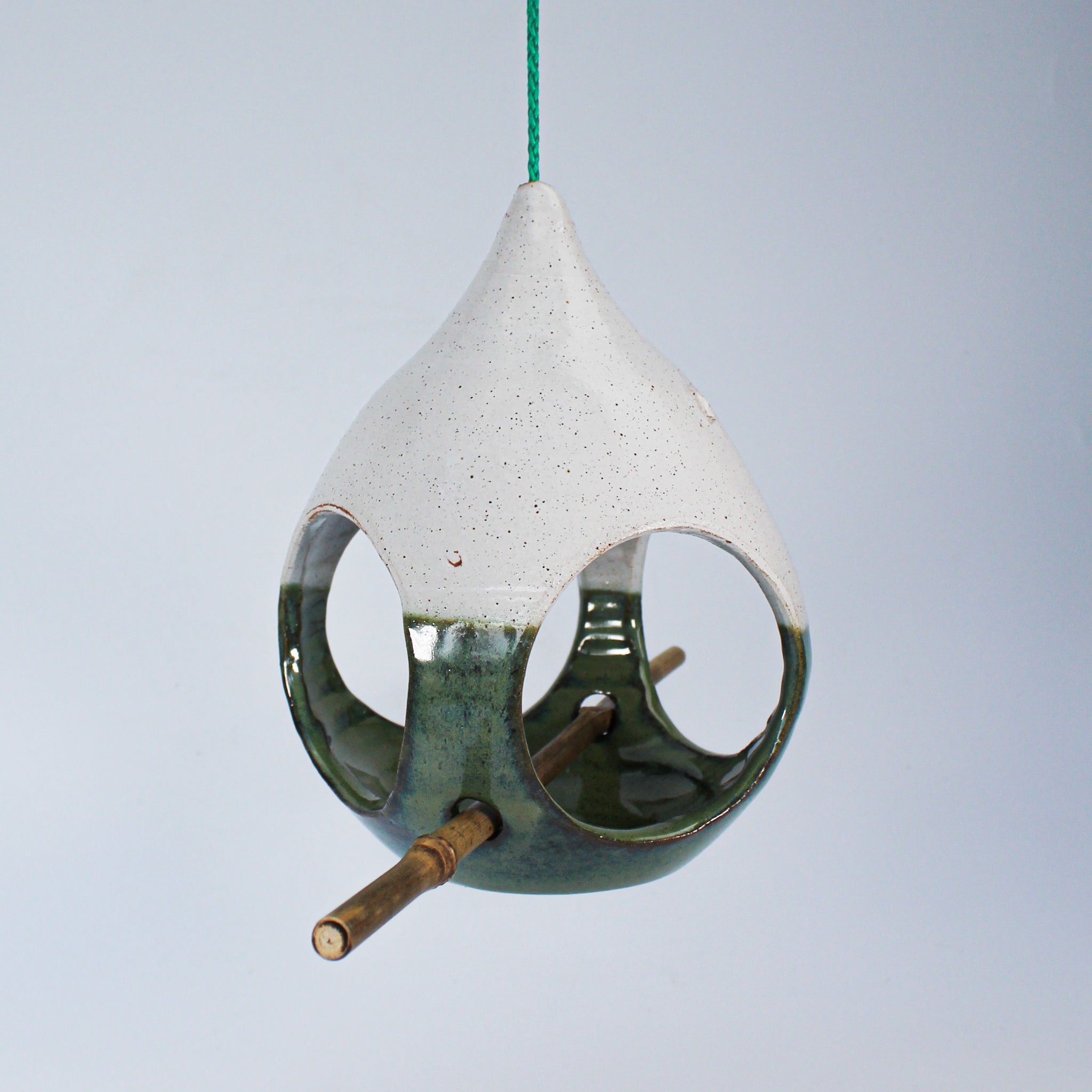 Hanging green and white ceramic bird feeder with bamboo perch 