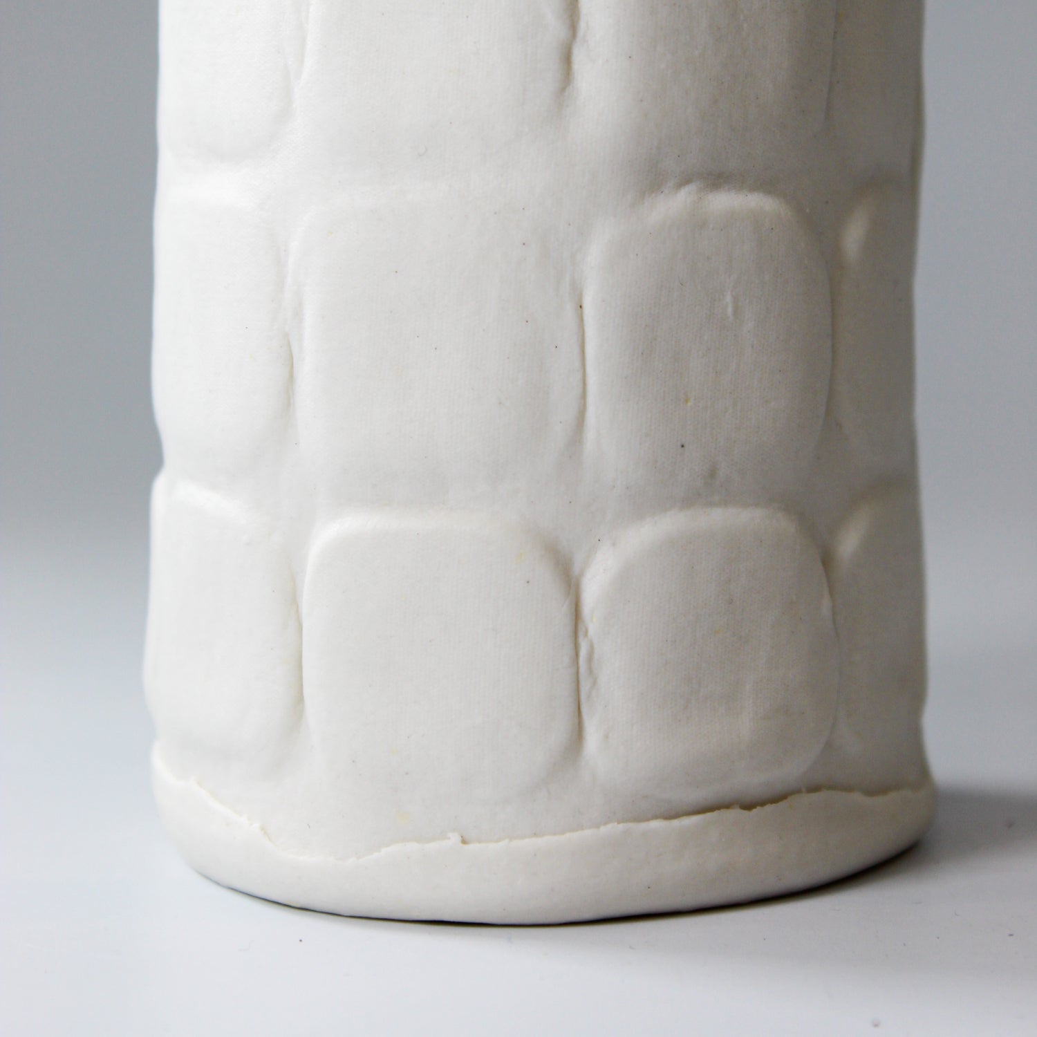 Close up of bottom of white porcelain vase 
