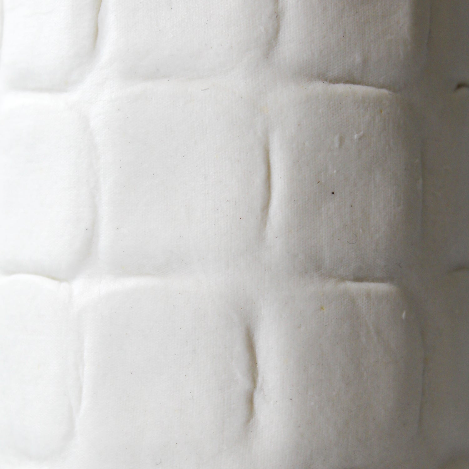Detail of tall white handmade porcelain vase 