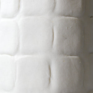Detail of tall white handmade porcelain vase 