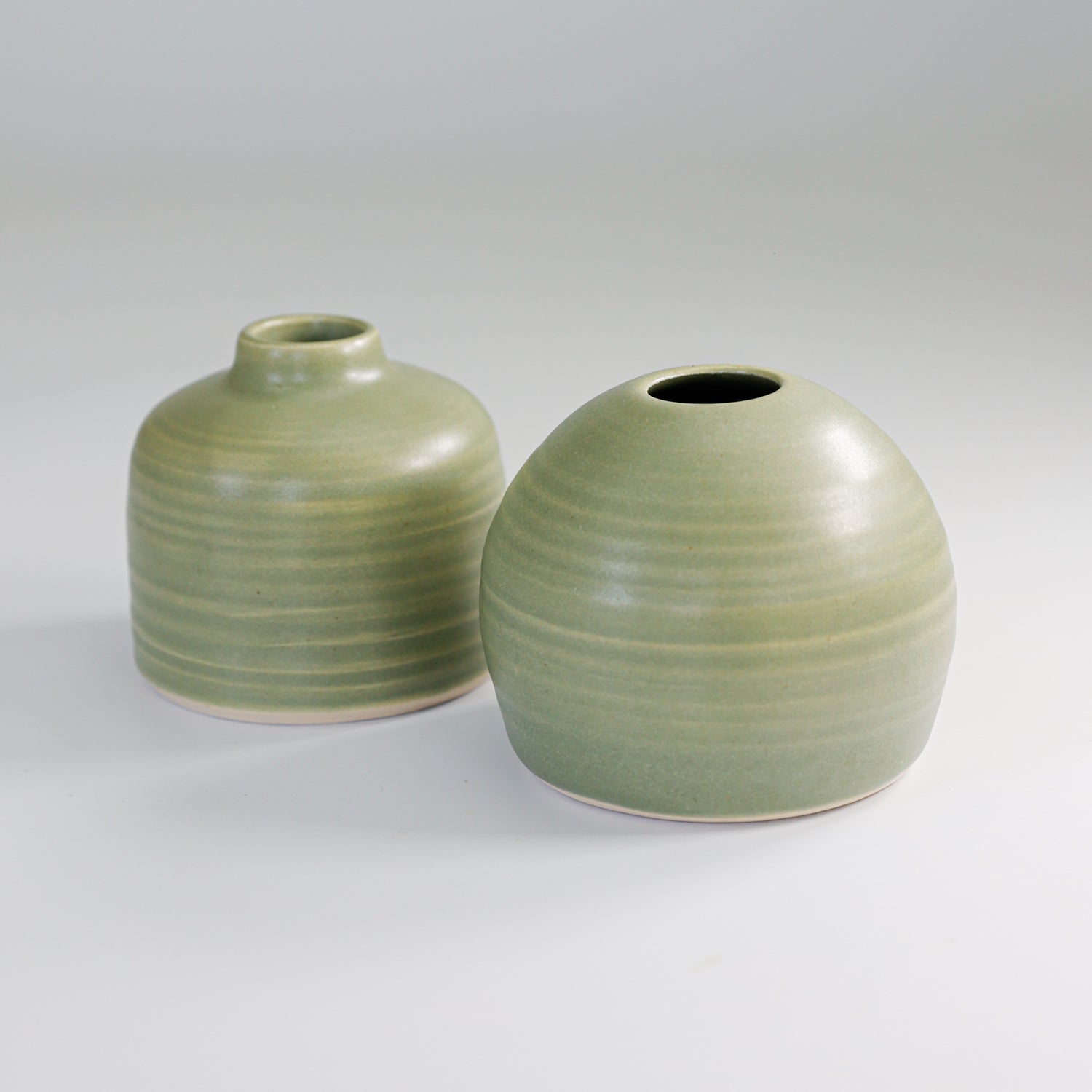 Pair of small green handmade ceramic bud vases 