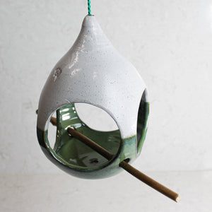 Hanging white and green ceramic bird feeder with bamboo perch 