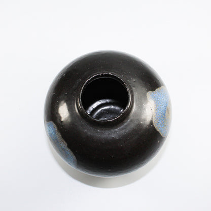 Inside of small black and blue ceramic vase