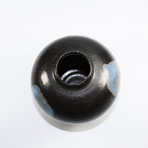 Inside of small black and blue ceramic vase