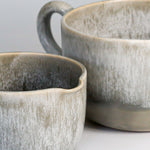 Load image into Gallery viewer, Close up of glazing detail on pair of grey glazed ceramic gravy jugs 
