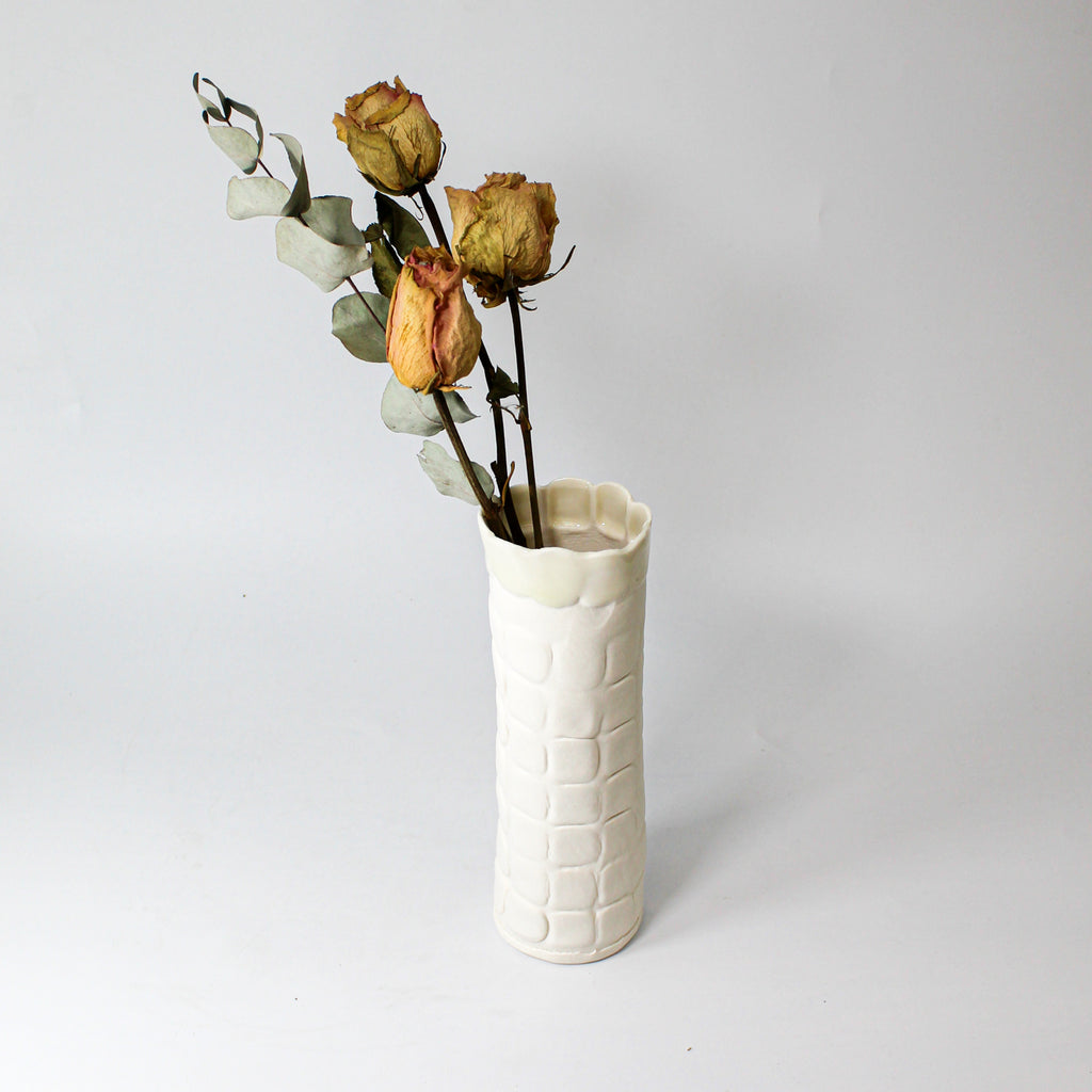 White porcelain handmade vase with dried flowers 