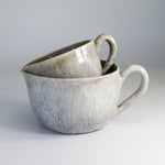 Load image into Gallery viewer, Two stacked grey glazed pottery gravy jugs 
