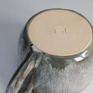 Bottom of grey glazed pottery gravy jug showing potter's mark
