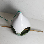 Load image into Gallery viewer, View from above of pottery green and white bird feeder with bamboo perch 
