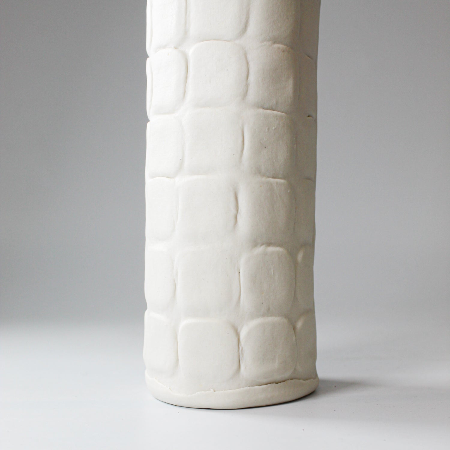 Bottom of tall slim handmade porcelain vase 